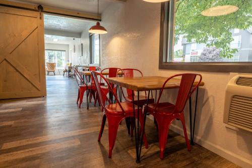 a dining room with a table and red chairs at The Junction Hotel and Hostel in Durango