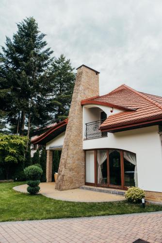a house with a balcony on the side of it at Zarabie Residence in Myślenice