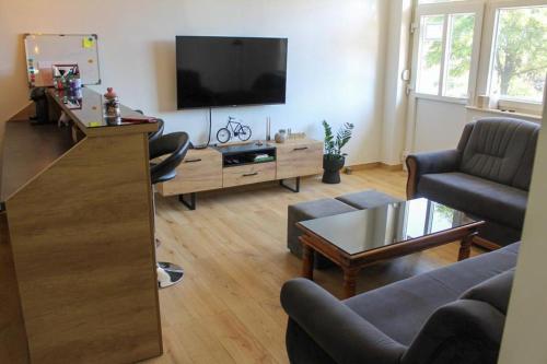 a living room with a flat screen tv and a couch at Apartman IM7 Međugorje in Međugorje