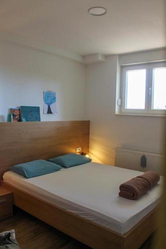 a bedroom with a large bed with blue pillows at Apartman IM7 Međugorje in Međugorje