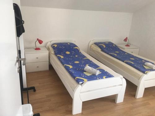 two beds in a room with a room with moon and stars at Apartman SUNCE in Jajce