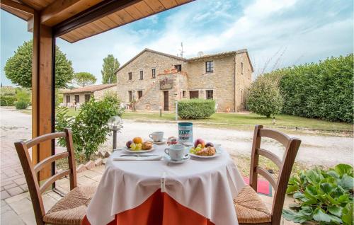 a table with fruit on it in front of a house at Awesome Apartment In Magione With Wifi in Magione
