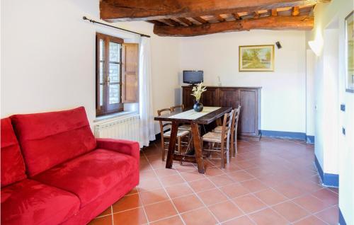 a living room with a red couch and a table at Awesome Apartment In Magione With Wifi in Magione