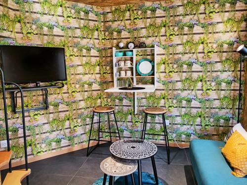 a living room with a wall covered in ivy at Mini House in Beauce in Toury