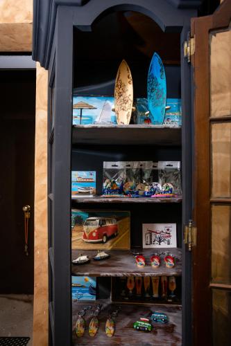 a cabinet filled with lots of toy cars and surfboards at Kais do Sol in Setúbal