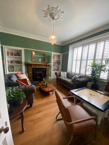 a living room filled with furniture and a chandelier at The old church house in Inverness