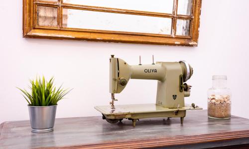 a sewing machine sitting on a table next to a window at Kais do Sol in Setúbal
