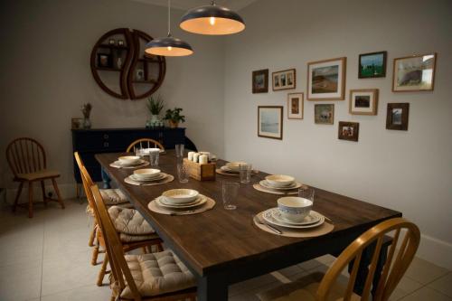 a wooden table with chairs and a dining room at The old church house in Inverness