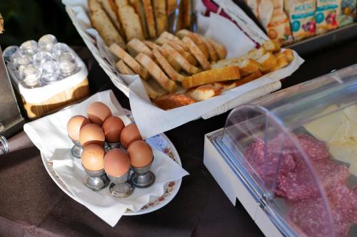 a table with eggs and french fries and bread at Hotel Club i Pini - Residenza d'Epoca in Versilia in Lido di Camaiore