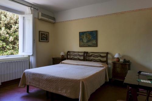 a bedroom with a bed and a window at Hotel Club i Pini - Residenza d'Epoca in Versilia in Lido di Camaiore