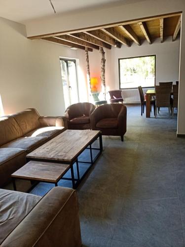 a living room with couches and a table at Zonga Chalet Catan in Waulsort