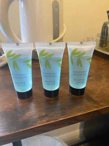 two bottles of sunscreen sitting on a table at Self-contained, Framlingham Snug, Private Parking, no cooking facilities in Framlingham