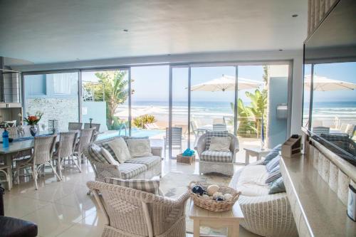 a living room with a view of the beach at Ti’amo in Wilderness