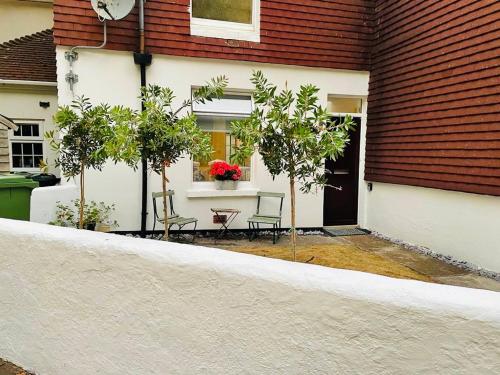 a porch of a house with a table and chairs at Funky cozy cottage with outside space in Eastbourne