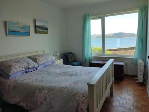 a bedroom with a bed and a large window at Tobar nan Iasgair Lismore in Achnacroish