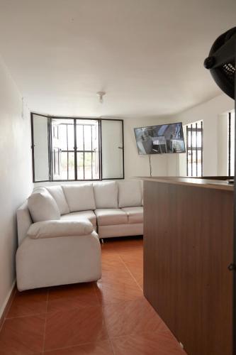 a living room with a couch and a table at Hotel Gran Girones in Girón