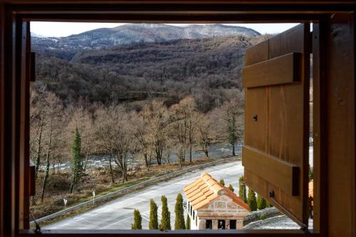 a view from a window of a house and a road at The House of the Miyaks in Rostuša
