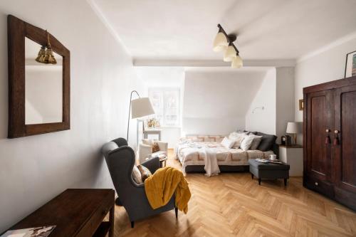 a bedroom with a bed and a chair and a table at Apartament City Express in Warsaw