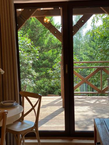 a door leading to a patio with a table and chairs at Anielski Zakątek Solina - balia z jacuzzi i sauna w cenie pobytu in Solina