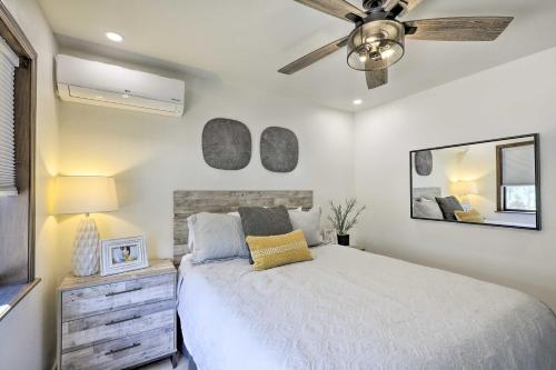 a bedroom with a bed and a ceiling fan at Wraparound Deck and Poker Room Cabin in Munds Park in Munds Park