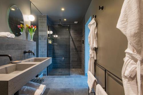 a bathroom with two sinks and a shower at Little Hayloft by Bloom Stays in Canterbury