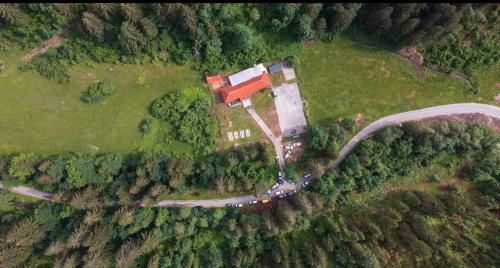 an aerial view of a house and a road in a field at Črjanski Raj in Črna na Koroškem
