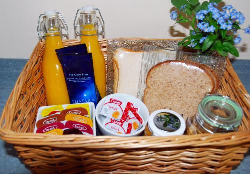 a basket filled with bread and drinks and condiments at Almond Court Motel in Alexandra