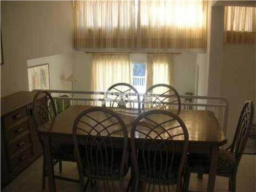 a dining room table with six chairs and a table and a dining room at Las terrazas de Cala Codolar in Sant Josep de Sa Talaia
