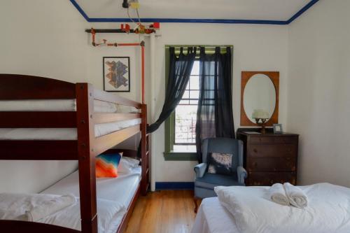 a bedroom with two bunk beds and a mirror at Amazing 3 Bedroom Apt! 11 Beds! in Providence