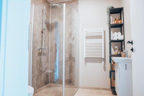a shower with a glass door in a bathroom at Hotel Kaldi in Litli-Árskógssandur