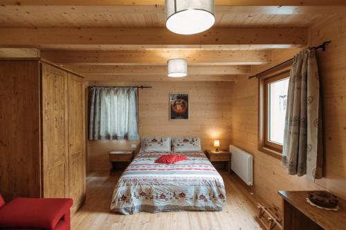 a bedroom with a bed in a wooden cabin at Chalet Gaspard in Valtournenche