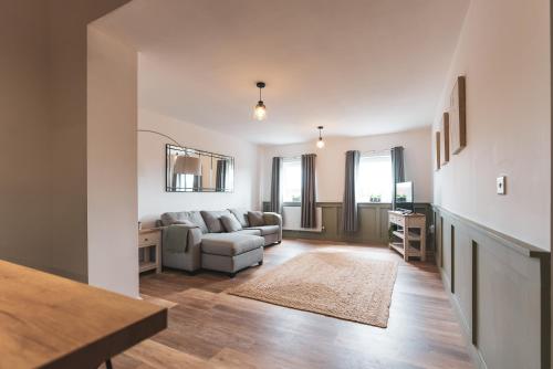 a living room with a couch and a table at The Old Band Accommodation in Higham Ferrers