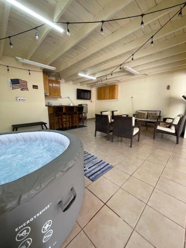 a large room with a hot tub in the middle of it at Seaside Adventure Lodging in Ensenada