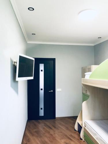 a room with a blue door and a tv at Seven Apart Hotel in Vyshneve