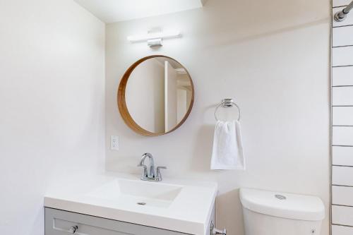 a white bathroom with a sink and a mirror at The Richey - Pastries Delivered To You!! in Tucson