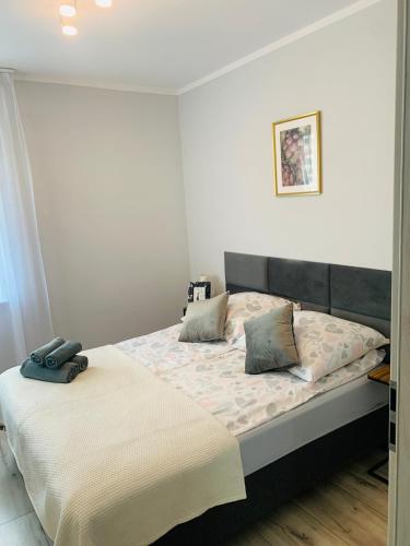 a bedroom with a bed with two pillows on it at Apartament Champion in Gorzów Wielkopolski