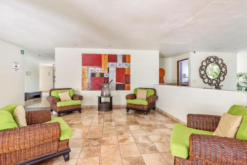 a living room with couches and chairs and a fireplace at Nitta 302 in Nuevo Vallarta 