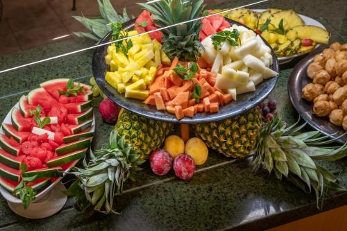a table with two plates of fruit and vegetables at Vilar Rural De Sant Hilari Sacalm by Serhs Hotels in Sant Hilari Sacalm
