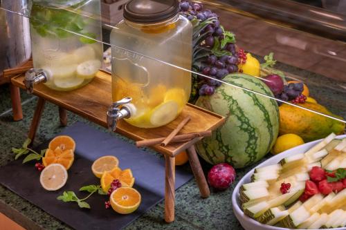 a table topped with fruit and a jar of honey at Vilar Rural De Sant Hilari Sacalm by Serhs Hotels in Sant Hilari Sacalm
