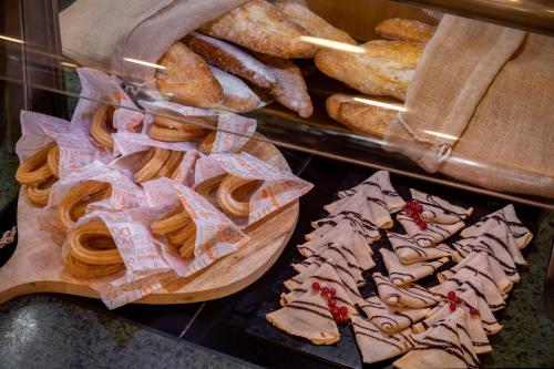 a display of bread and pastries in a bakery at Vilar Rural De Sant Hilari Sacalm by Serhs Hotels in Sant Hilari Sacalm