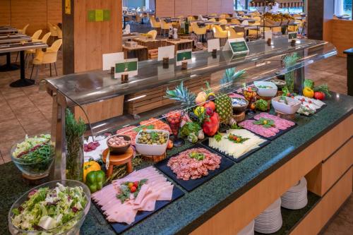 a buffet line with different types of food on display at Vilar Rural De Sant Hilari Sacalm by Serhs Hotels in Sant Hilari Sacalm