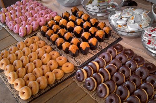 a display of different types of donuts on a table at Vilar Rural De Sant Hilari Sacalm by Serhs Hotels in Sant Hilari Sacalm
