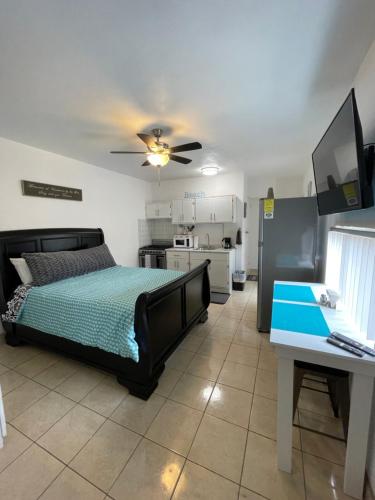 a bedroom with a bed and a ceiling fan at Seaside Adventure Lodging in Ensenada