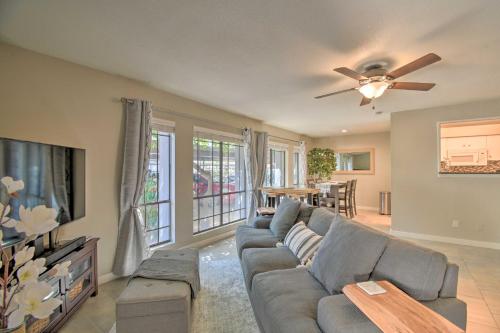 a living room with a couch and a flat screen tv at Sleek Phoenix Condo Walk to Biltmore Fashion Park in Phoenix