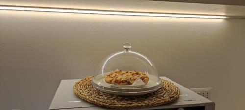 a cake under a glass dome on a table at Casa Pellegrino in Polignano a Mare