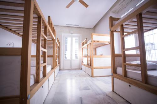 a room with a bunch of bunk beds at The Nomad Hostel&Pension in Seville