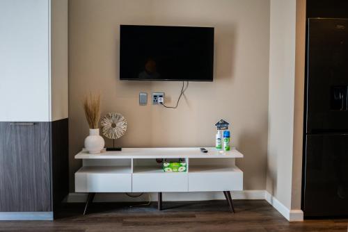 a white cabinet with a tv on a wall at 703 Menlyn Maine Residences, The Trilogy in Pretoria