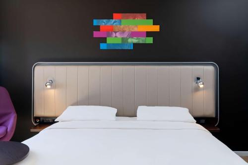 a bedroom with two beds and a painting on the wall at Park Inn by Radisson Polokwane in Polokwane