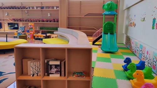 a play room with a slide and a playground at Holiday Inn Shanghai Dishui Lake by IHG in Nanhui
