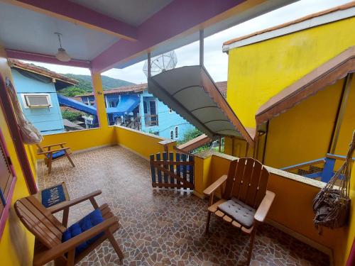 an overhead view of a balcony with two chairs at Pousada Pedacinho de Céu in Abraão